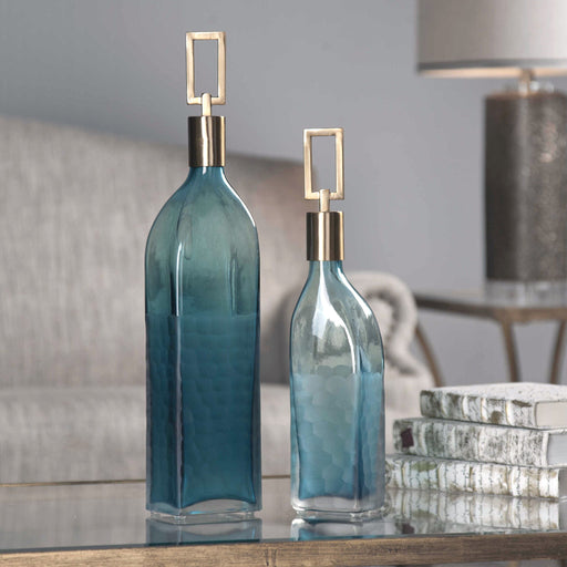 Set of two teal glass bottles from Uttermost Annabella vases, featuring elegant, rounded shapes for decorative display.