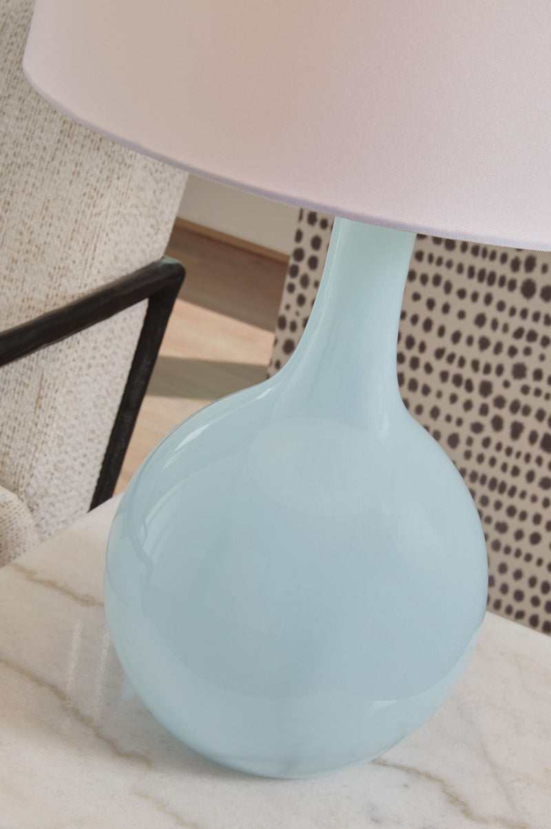 Signature Design by Ashley aqua glass table lamp with a sleek, modern design and clear glass base for stylish home lighting.
