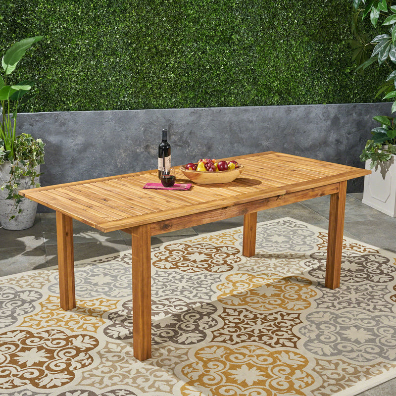 Outdoor expandable dining table with square legs by Noble House, showing its wooden surface and adjustable size for outdoor meals.