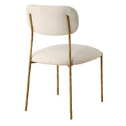 Set of two Capture dining chairs by Uttermost with gold and white upholstery, featuring modern design and sleek metal legs.