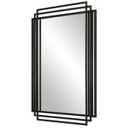Uttermost Amherst wall mirror with a sleek, modern frame, hanging on a wall with a subtle reflection in the glass surface.