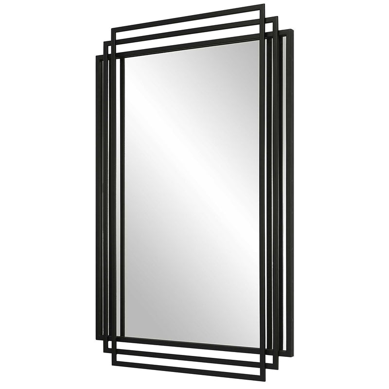 Uttermost Amherst wall mirror with a sleek, modern frame, hanging on a wall with a subtle reflection in the glass surface.