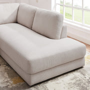 Ashcroft Furniture Glander cozy sectional sofa with plush cushions and neutral fabric, perfect for a comfortable living room setup.
