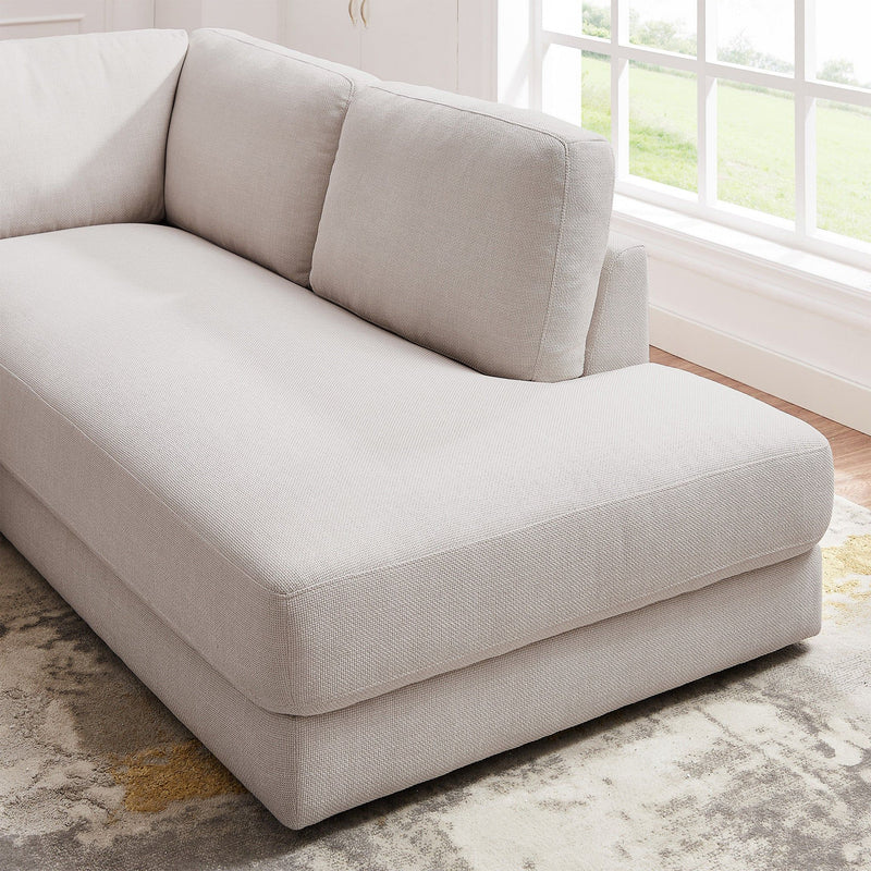 Ashcroft Furniture Glander cozy sectional sofa with plush cushions and neutral fabric, perfect for a comfortable living room setup.