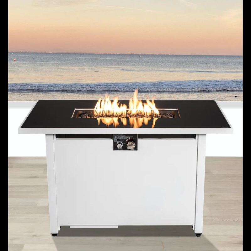 White outdoor rectangular fire pit table with adjustable flame control, 43 inches long by LSI Patio Furniture, surrounded by outdoor seating.