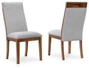 Set of two beige and brown upholstered dining side chairs by Signature Design by Ashley, showcasing cushioned seats and wooden legs.