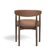 Vina vegan leather arm dining chair by TOV Furniture with cushioned seat and modern design, shown in a contemporary dining room setting.