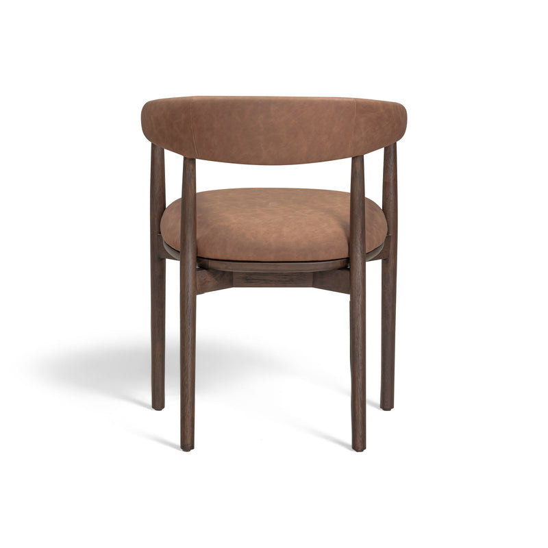 Vina vegan leather arm dining chair by TOV Furniture with cushioned seat and modern design, shown in a contemporary dining room setting.