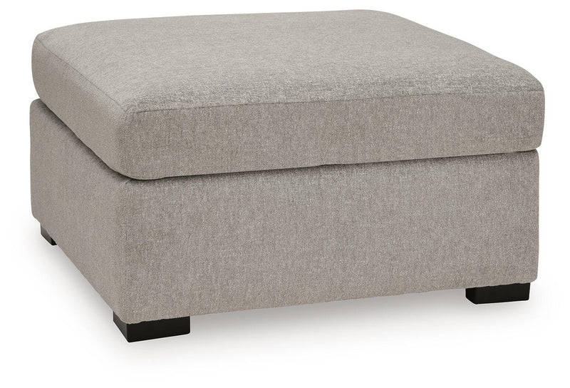 Benchcraft ModMax Luxe oversized accent ottoman in Flint fabric, showing its plush, contemporary design and sturdy construction.