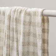 Natural ivory throw blanket from Classic Home, 50x70 inches, soft fabric with a subtle woven texture for cozy decor.