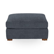 Classic Home Audrey upholstered ottoman with cushioned top and wooden legs, versatile for living room or bedroom décor.