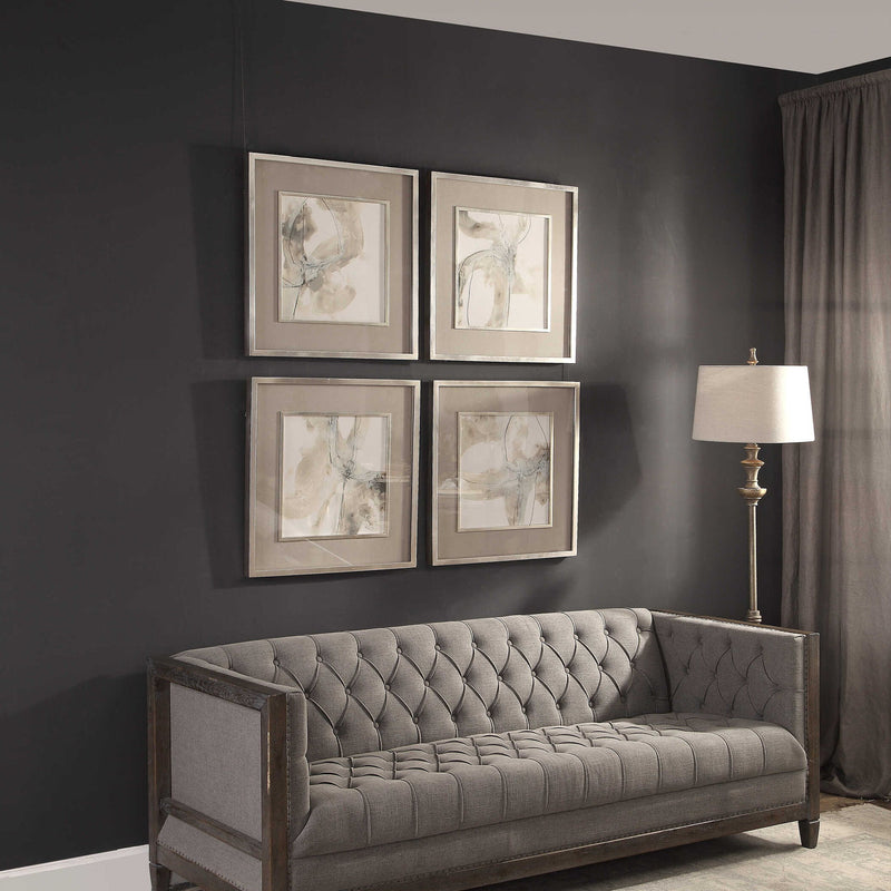 Set of four beige framed abstract art prints by Uttermost, featuring modern divination-inspired designs for wall decor.