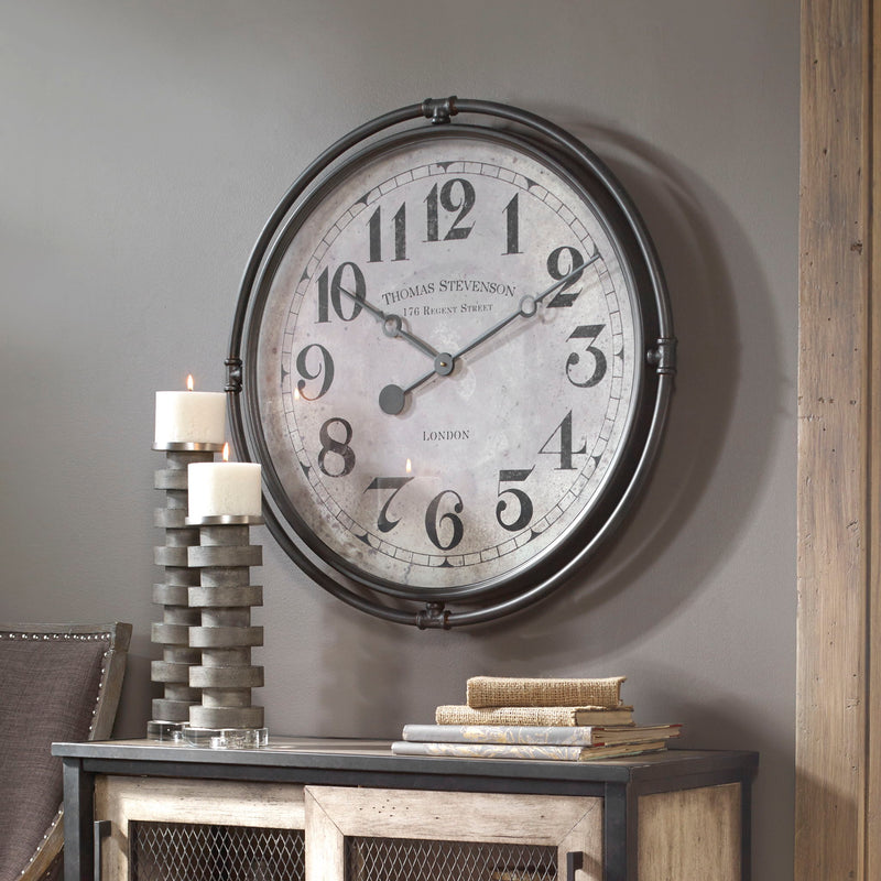 Nakul industrial wall clock by Uttermost featuring a pearl silver finish and bold, modern design on a plain background.