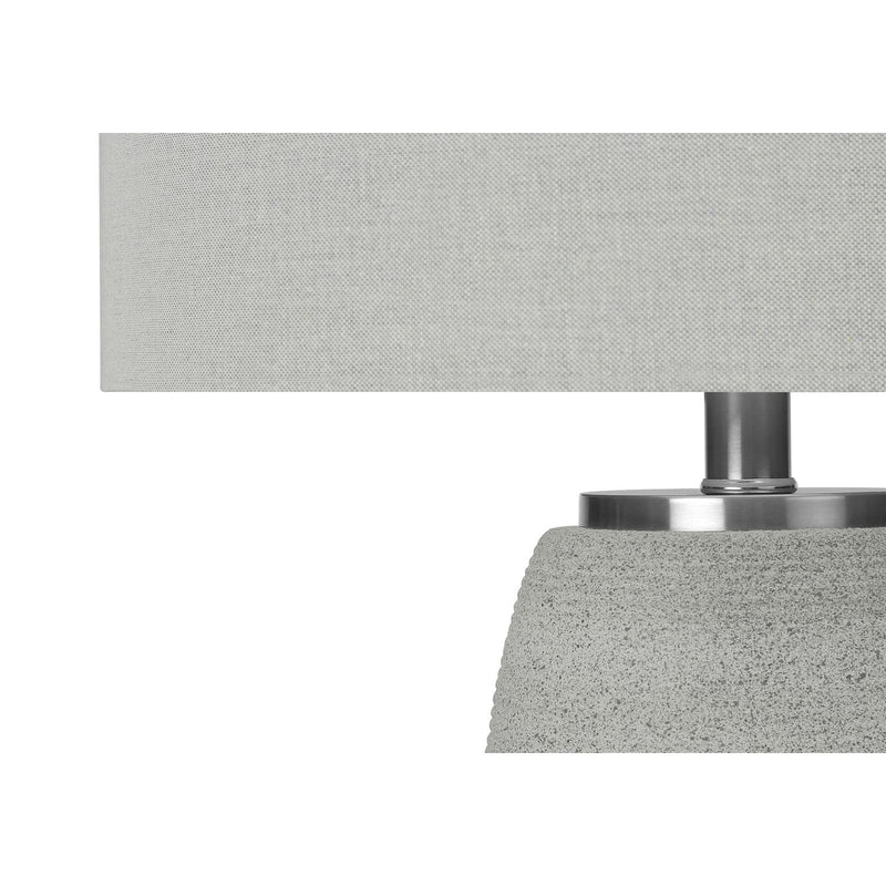 Gray ceramic table lamp by 8th Street with modern design, featuring a smooth, rounded shape and a fabric lampshade.