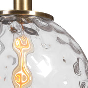Uttermost Mimas 1 Light Globe Pendant in gold with a sleek, modern design, hanging from a ceiling fixture.