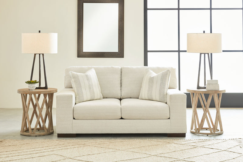 Signature Design by Ashley Maggie living room set with stationary chair and ottoman in neutral upholstery, modern and comfortable.