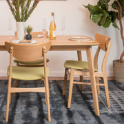 Noble House contemporary dining side chair with sleek modern design and smooth wood finish, shown from a side angle.