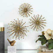Set of three gold metal wall decor pieces by Uttermost, modern geometric wall art for contemporary interior design.