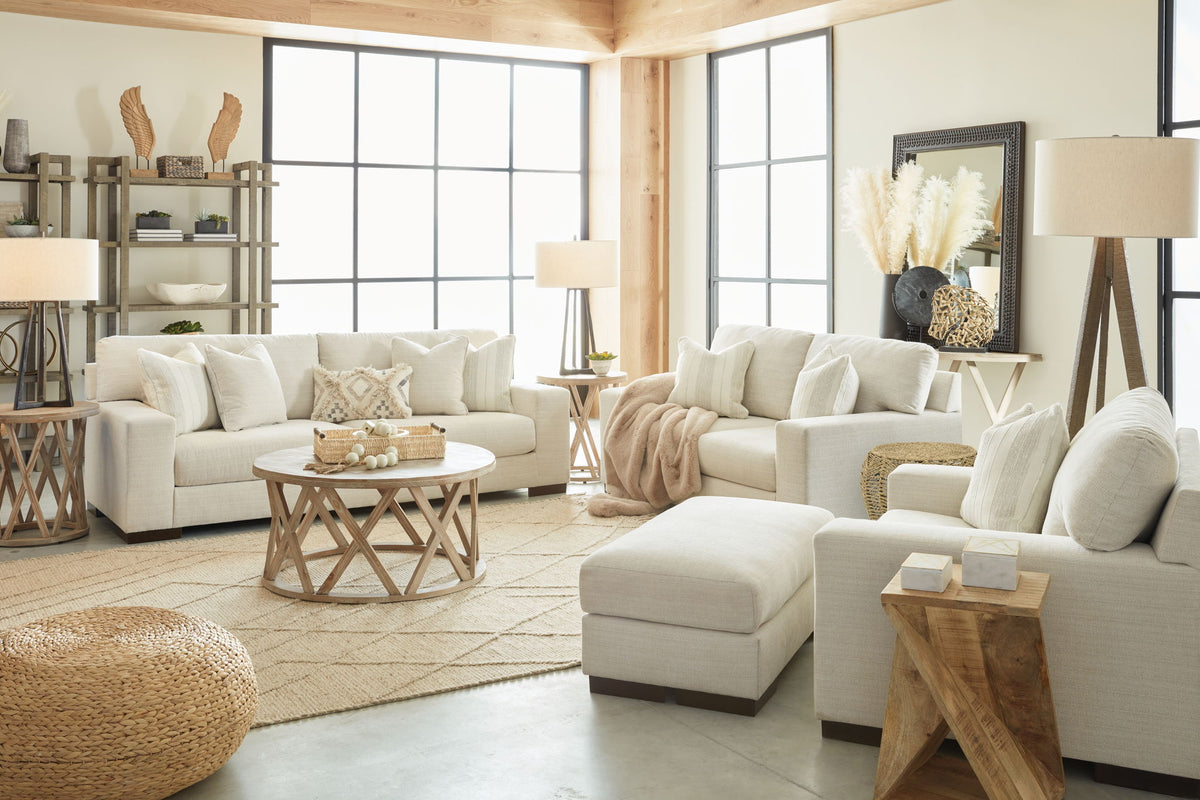 Signature Design by Ashley Maggie living room set with stationary chair and matching ottoman in neutral fabric.