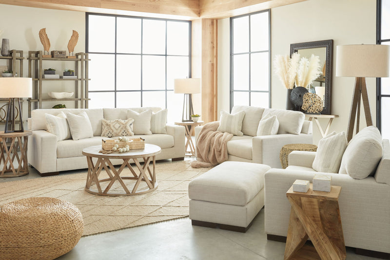 Signature Design by Ashley Maggie living room set with stationary chair and matching ottoman in neutral fabric.