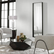 Uttermost Kahn black oversized rectangular accent mirror with a sleek modern frame, hanging on a wall.
