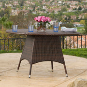Noble House Corsica round brown dining table with a smooth wooden surface, ideal for modern dining room setups.