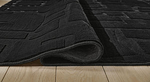 Signature Design by Ashley washable rug with colorful geometric pattern, durable and soft indoor floor covering.