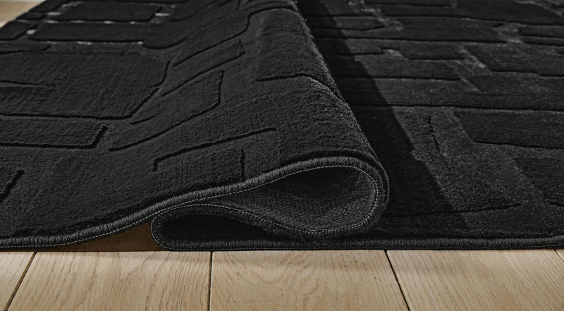 Signature Design by Ashley washable rug with colorful geometric pattern, durable and soft indoor floor covering.
