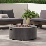 Round iron fire pit from Noble House with a 40,000 Btu burner, featuring a stylish design perfect for outdoor heating and ambiance.