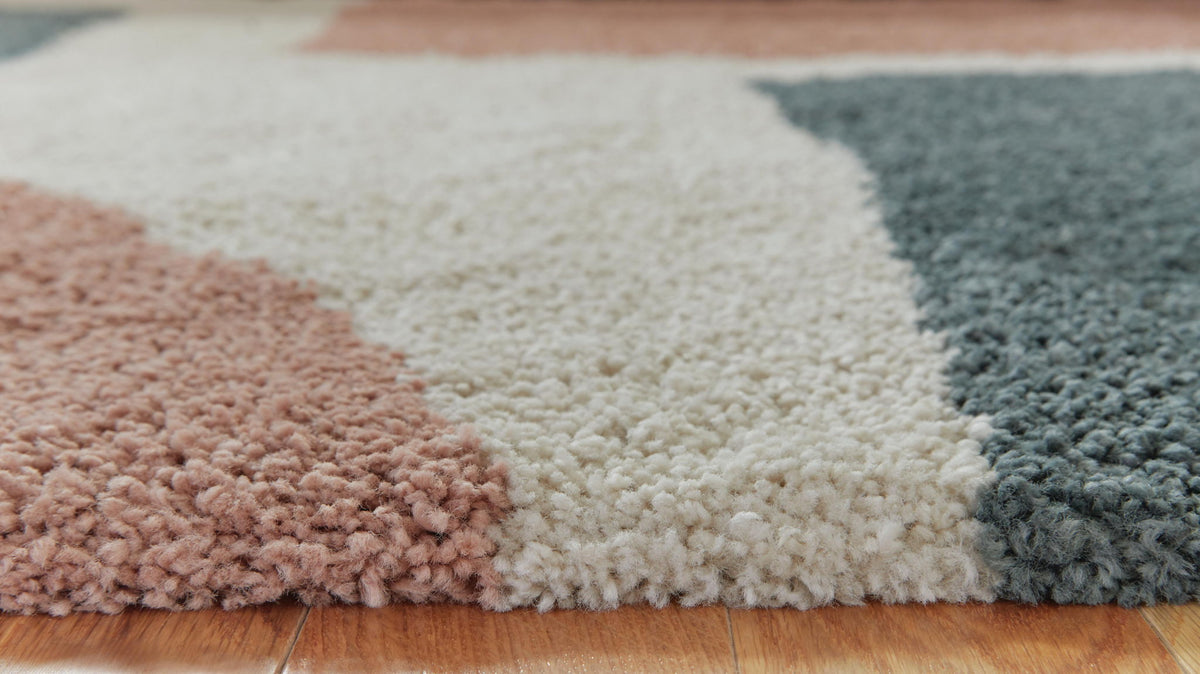 Signature Design by Ashley Flynnwick area rug with geometric pattern in neutral tones, perfect for modern living rooms.