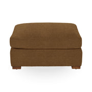 Classic Home Audrey upholstered ottoman with plush fabric and wooden legs, ideal as a versatile footstool or accent piece.