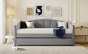 DreamHaus upholstered daybed sofa bed with trundle and wood slat base, shown with cushions and wooden frame in a cozy room setting.