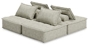 Signature Design by Ashley stationary sectional sofa with plush cushions and fabric upholstery, shown in a modern living room setting.