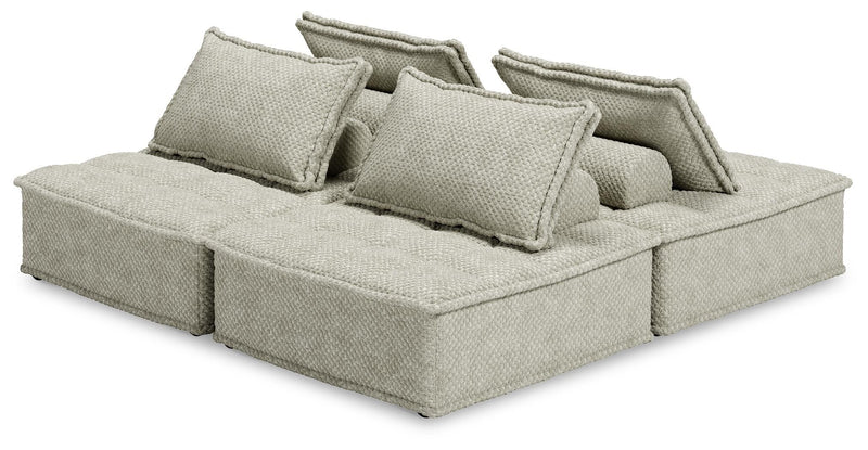 Signature Design by Ashley stationary sectional sofa with plush cushions and fabric upholstery, shown in a modern living room setting.