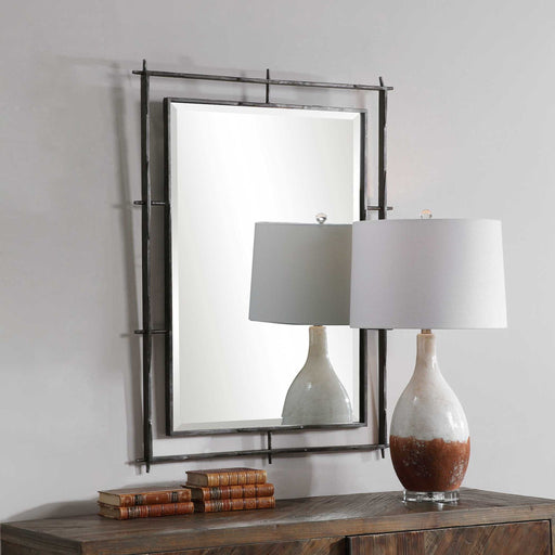 Uttermost Ironworks industrial black wall mirror with a sturdy metal frame and vintage-inspired design.