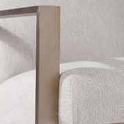 Beige contemporary accent arm chair by Uttermost with plush upholstery and modern design, suitable for living room or bedroom decor.