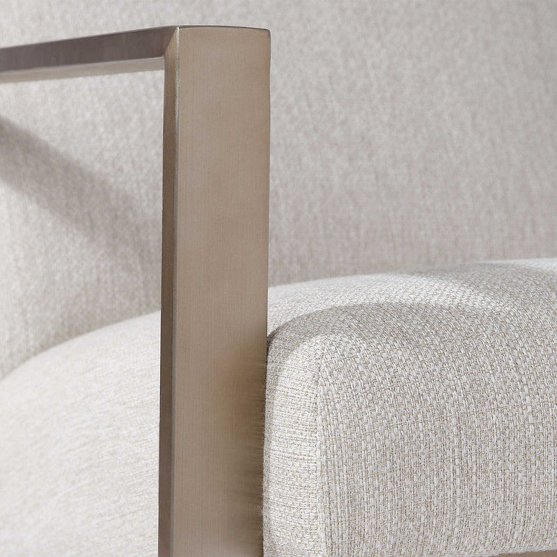 Beige contemporary accent arm chair by Uttermost with plush upholstery and modern design, suitable for living room or bedroom decor.