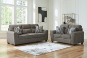 Benchcraft Olten living room set with stationary chair and matching ottoman, featuring plush upholstery and modern design.