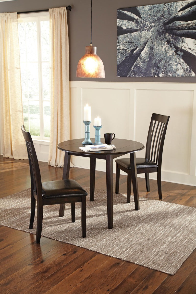 Dark brown round DRM Drop Leaf dining table by Signature Design by Ashley, with drop leaves and sturdy wooden construction.