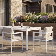 Set of two Noble House all-weather outdoor dining chairs with armrests and slatted seats, ideal for patio or garden dining.
