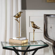 Light brown passerine bird sculptures set of 2 by Uttermost, detailed figurines showcasing natural bird poses and craftsmanship.