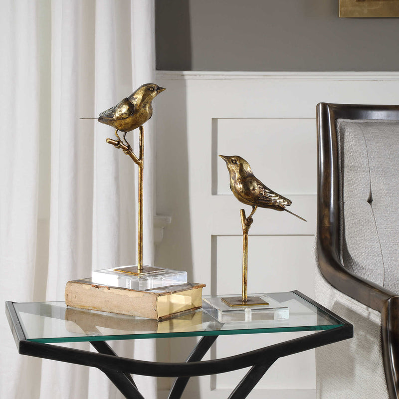 Light brown passerine bird sculptures set of 2 by Uttermost, detailed figurines showcasing natural bird poses and craftsmanship.