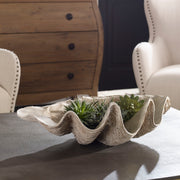 Beige clam shell bowl by Uttermost, decorative ceramic plate with textured shell design for table display or decor.