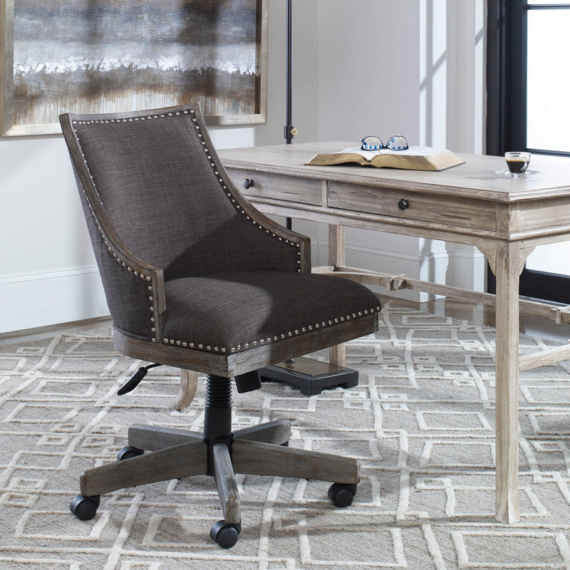Aidrian charcoal desk chair by Uttermost featuring a modern design with upholstered seat and backrest on sleek metal legs.