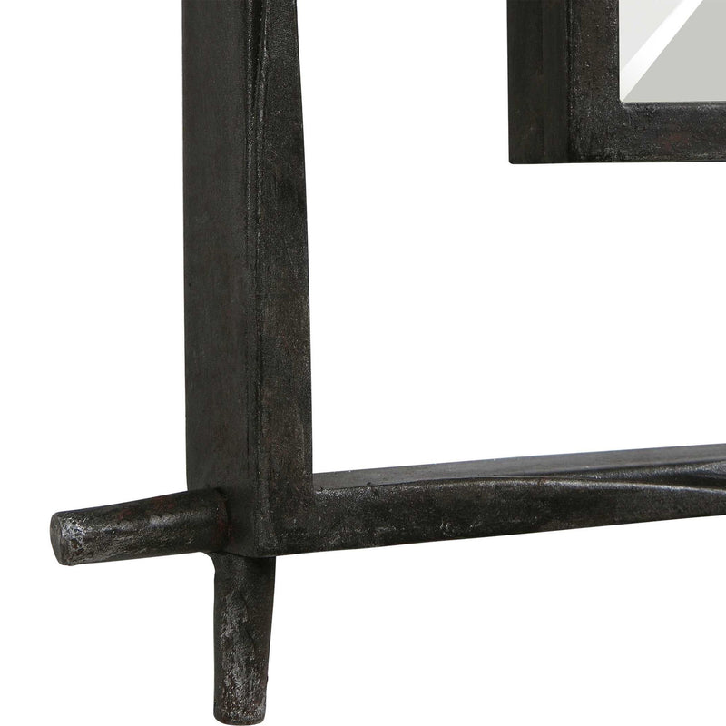 Black industrial wall mirror by Uttermost, featuring a rugged metal frame with a reflective glass surface for stylish home decor.