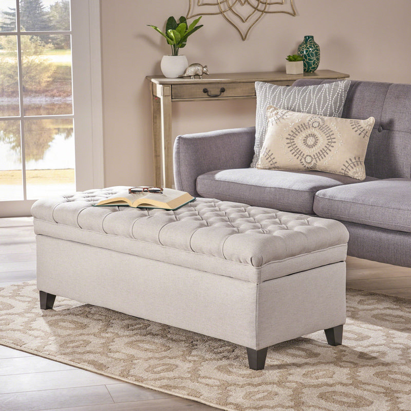 Noble House Juliana storage ottoman with birch legs, beige fabric top, and wooden base, designed for versatile home use.
