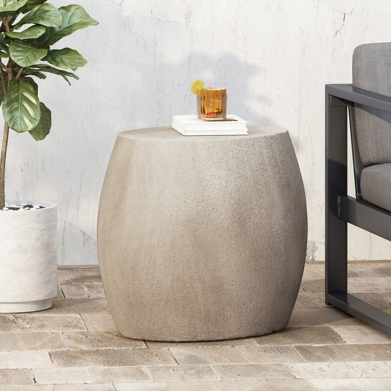 Outdoor oval-shaped side table by Noble House, featuring a sleek design with a smooth surface and sturdy legs.