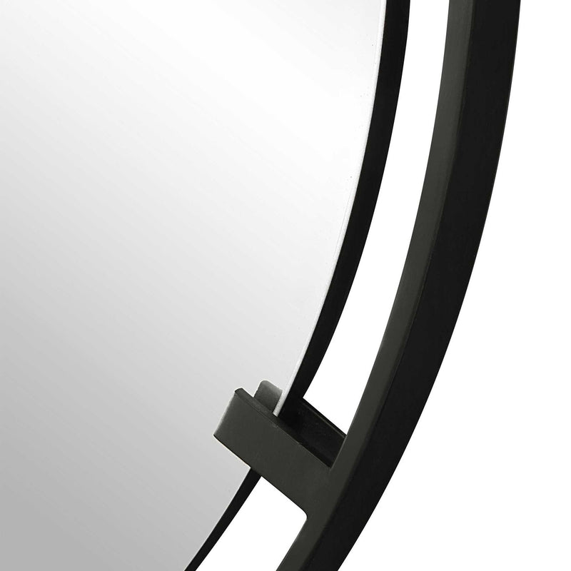 Black round iron accent mirror by Uttermost, featuring a sleek metal frame and modern design for stylish wall decor.
