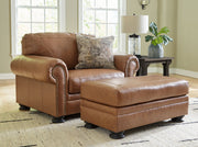Signature Design by Ashley Carianna living room set with stationary chair and ottoman in a cozy, stylish home setting.
