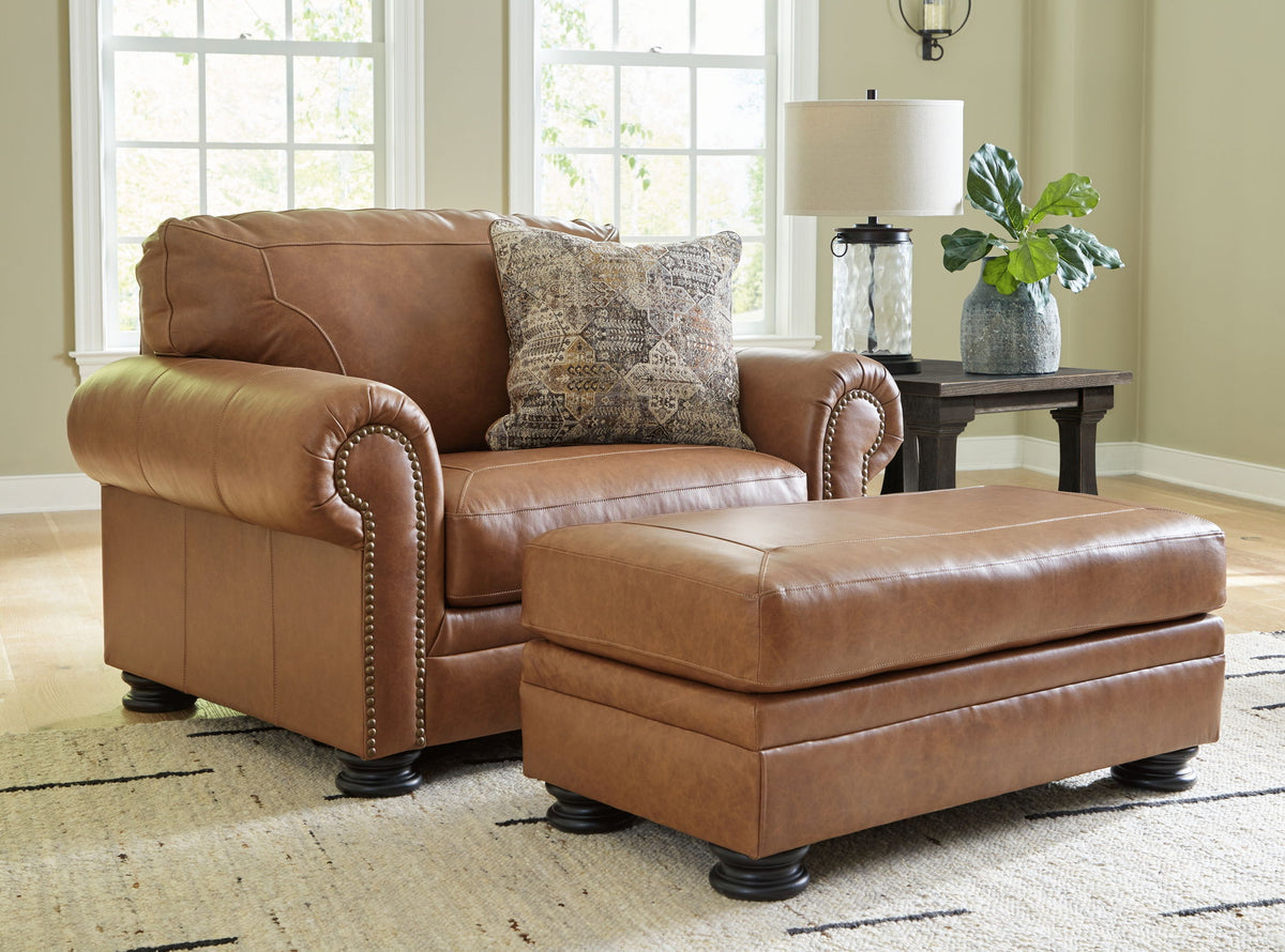 Signature Design by Ashley Carianna living room set with stationary chair and ottoman in a cozy, stylish home setting.